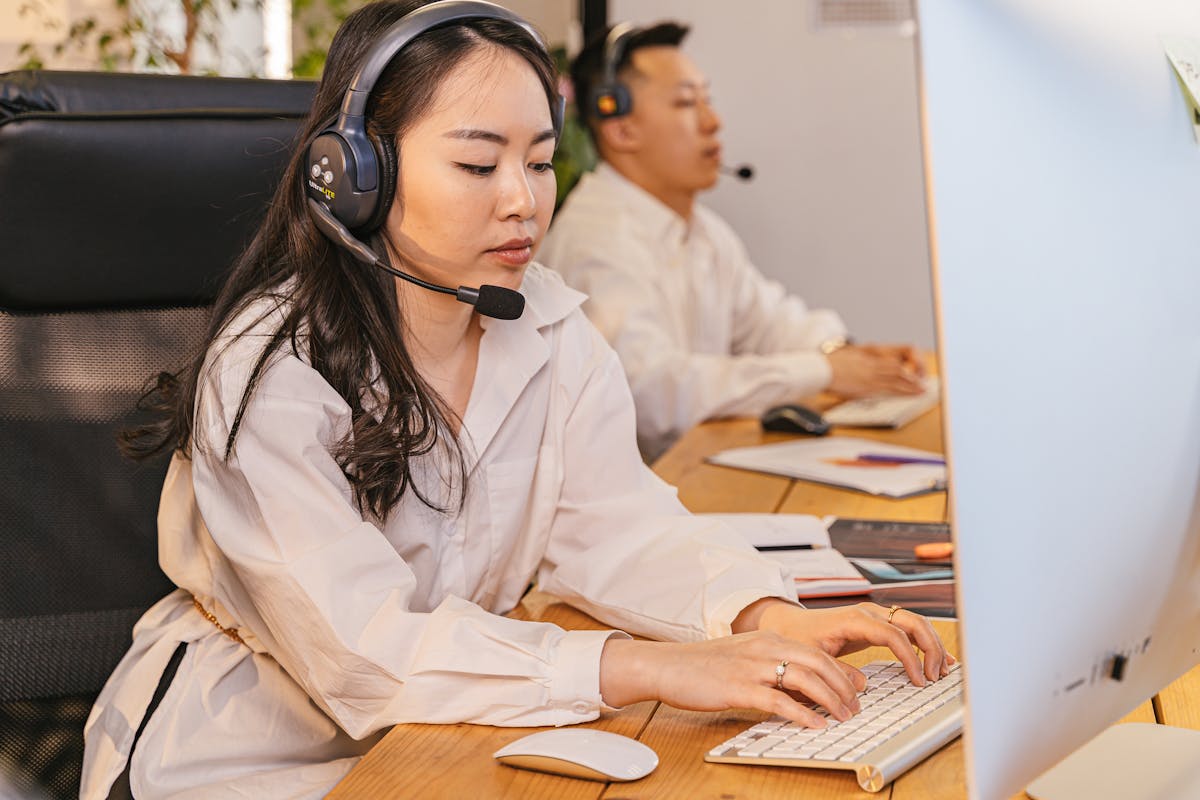 Customer support team wearing headsets in a modern office